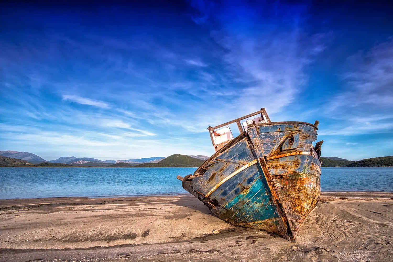 The Aging Beauty Of Isolation - A Rusty Boat Stranded Ashore