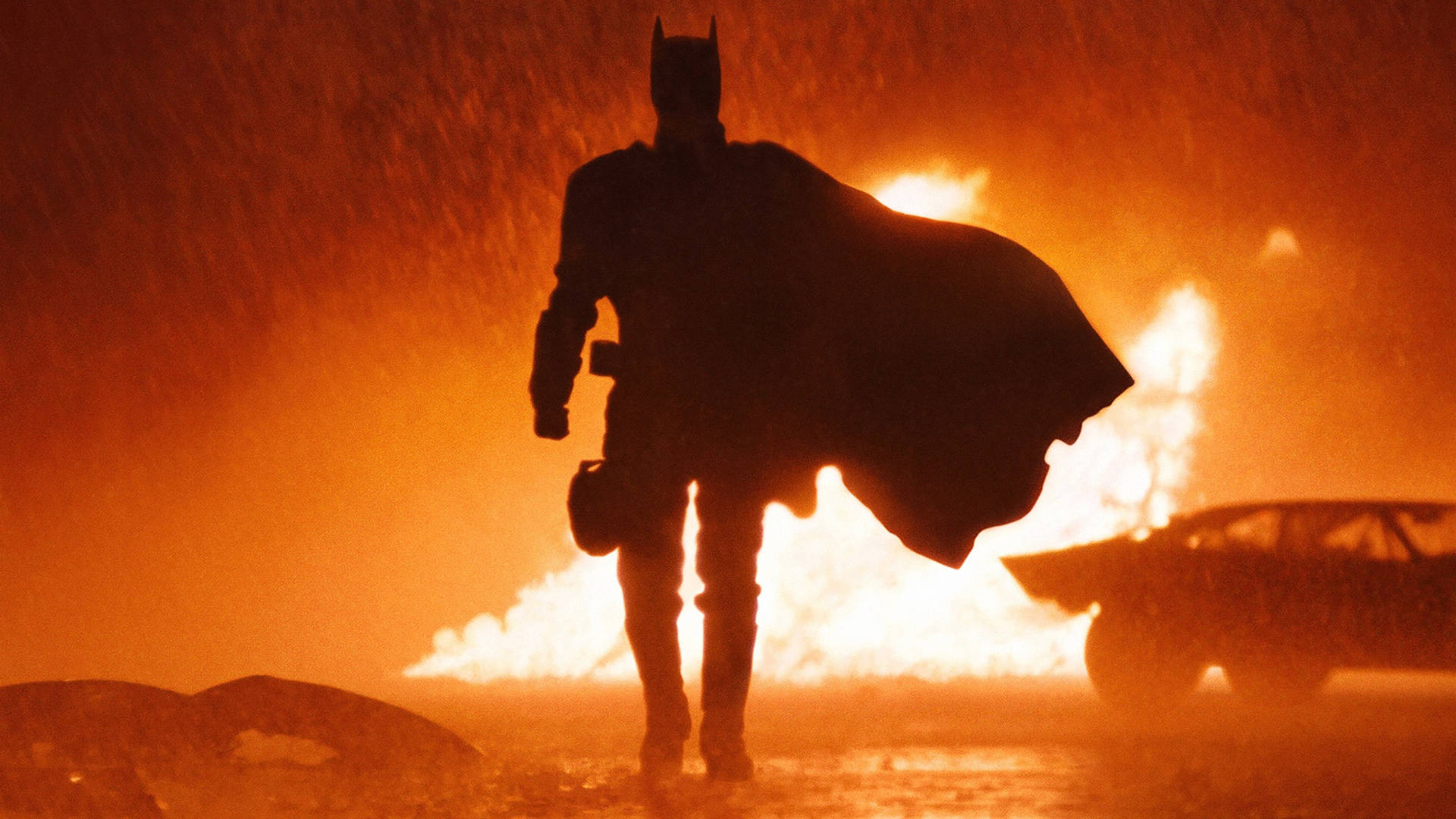The Batman Walking Away From Flames Background