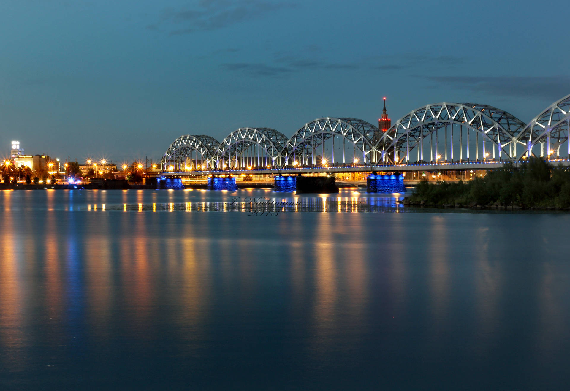 The Beautiful Riga's Railway Bridge At Night Background