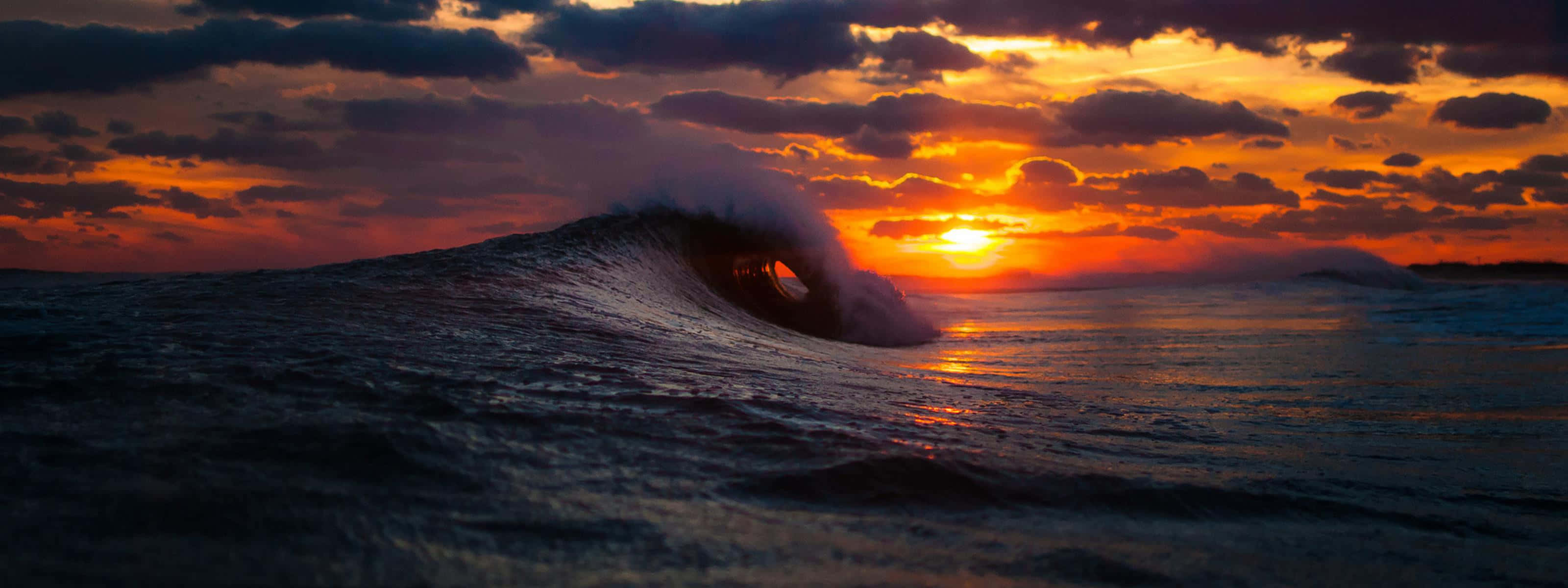 The Beauty Of A Unique Sunset Reflected In The Waves Background