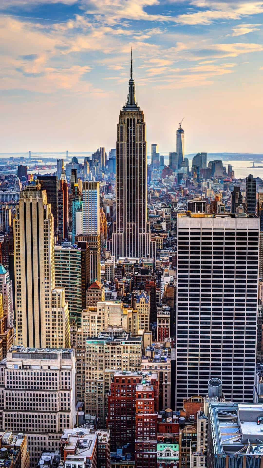 The Big Apple Skyline Illuminated Against The Night Sky Background