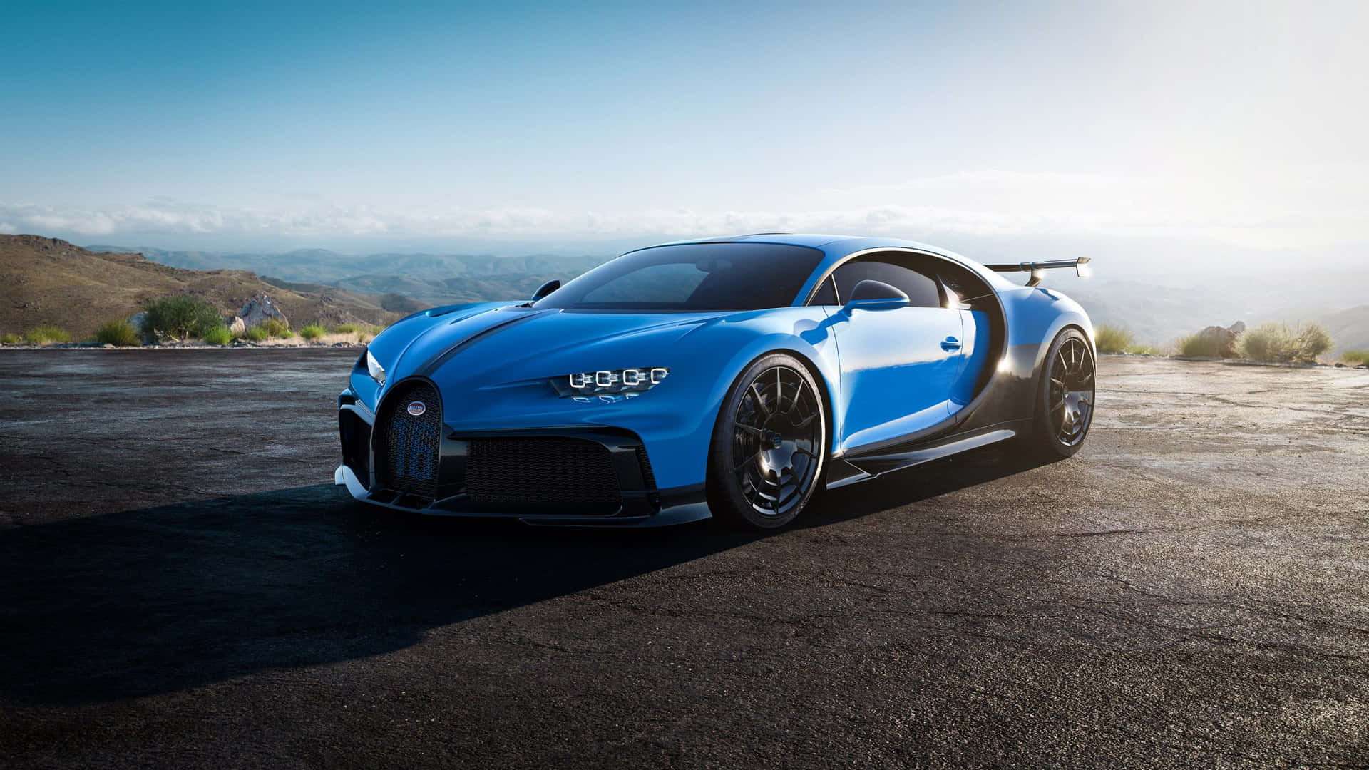 The Blue Bugatti Chiron Is Parked On A Mountain Background