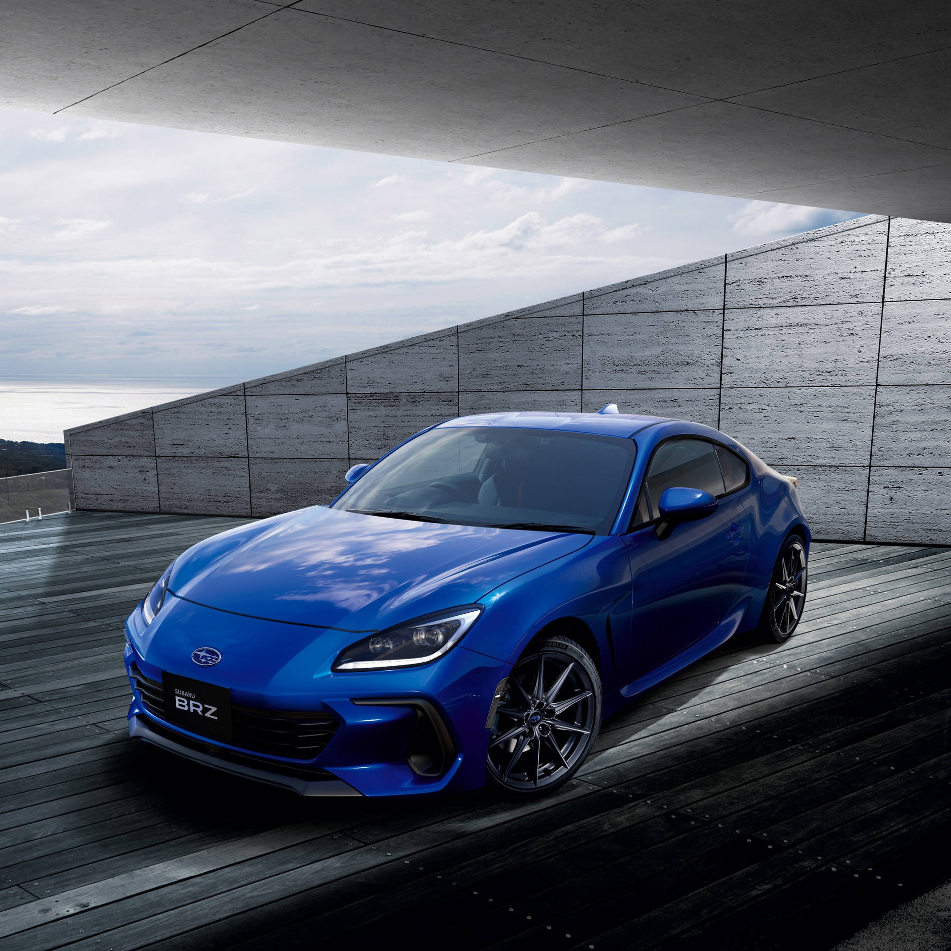 The Blue Toyota 86 Sports Car Is Parked On A Concrete Floor Background