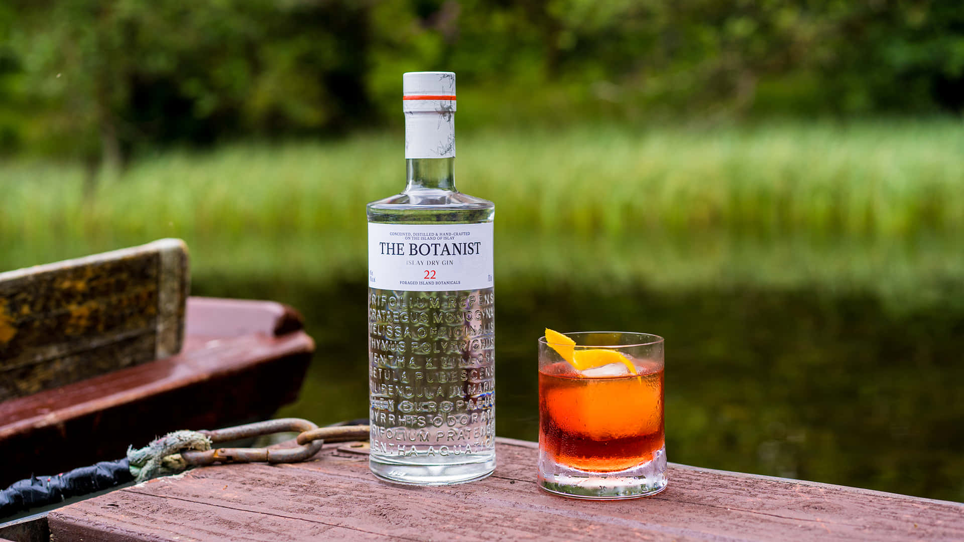 The Botanist Islay Dry Gin Alcoholic Drink By A Grassfield Background