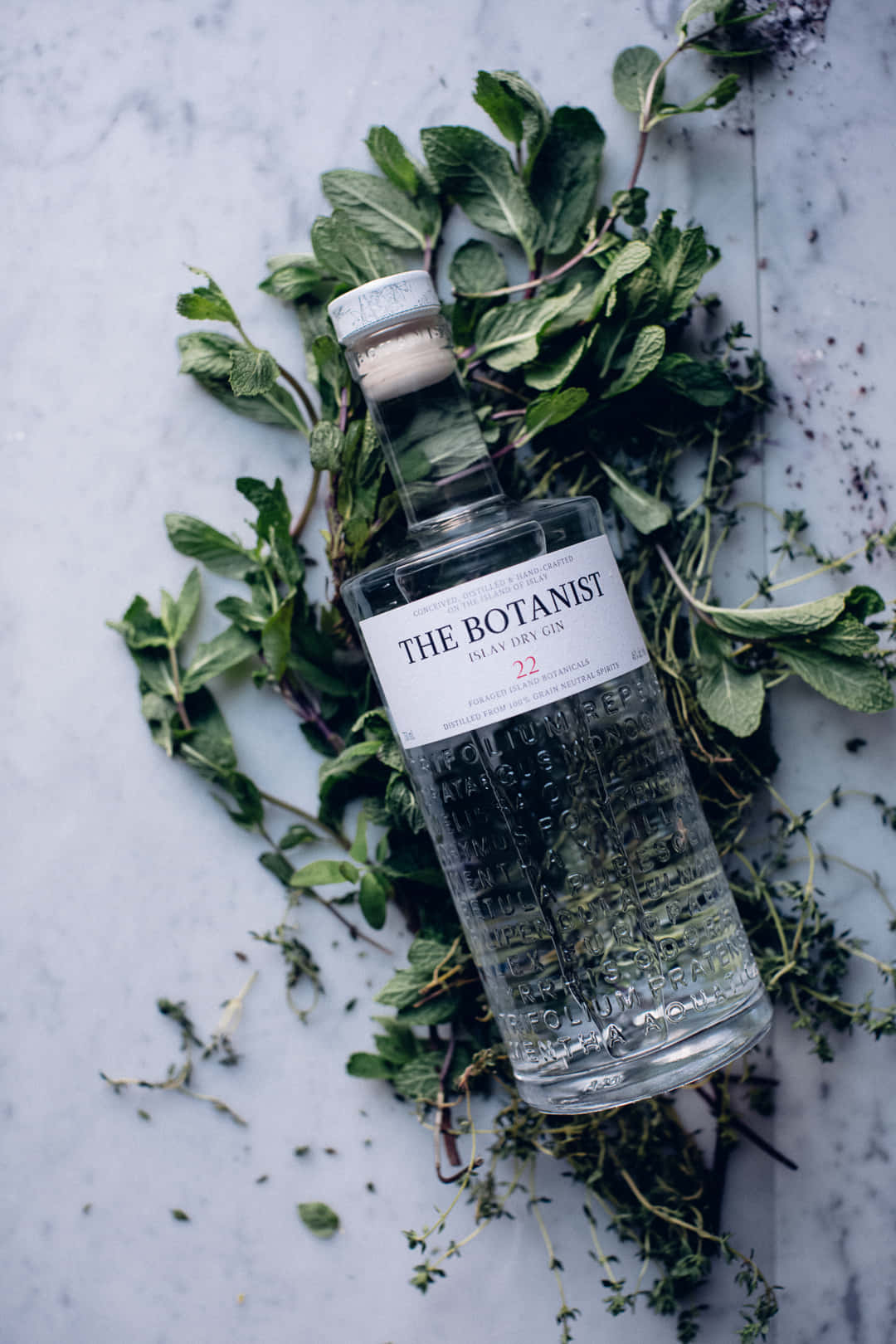 The Botanist Islay Dry Gin Alcoholic Drink In Khat Leaves Background