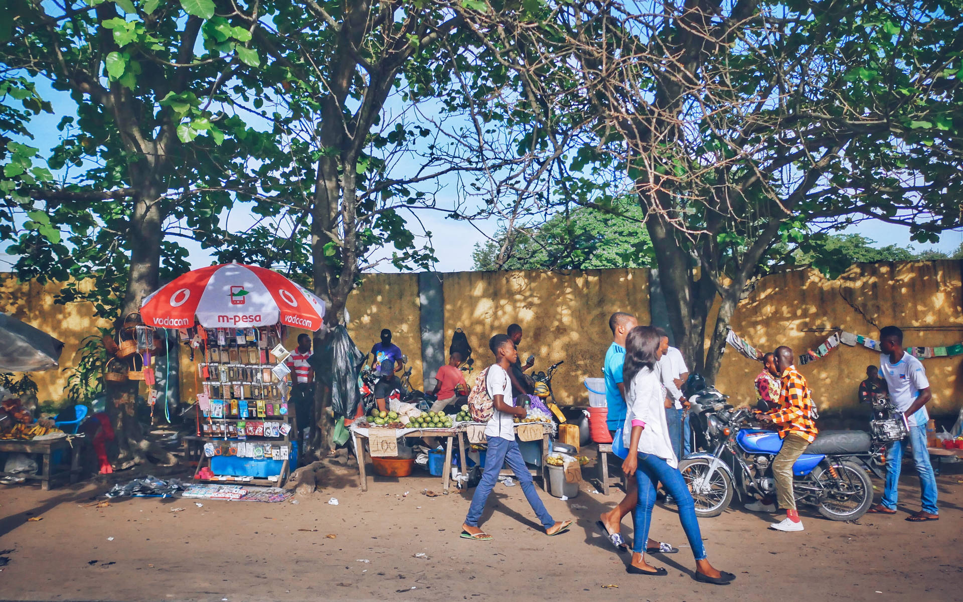 The Bustling Street Market In Kinshasa. Background