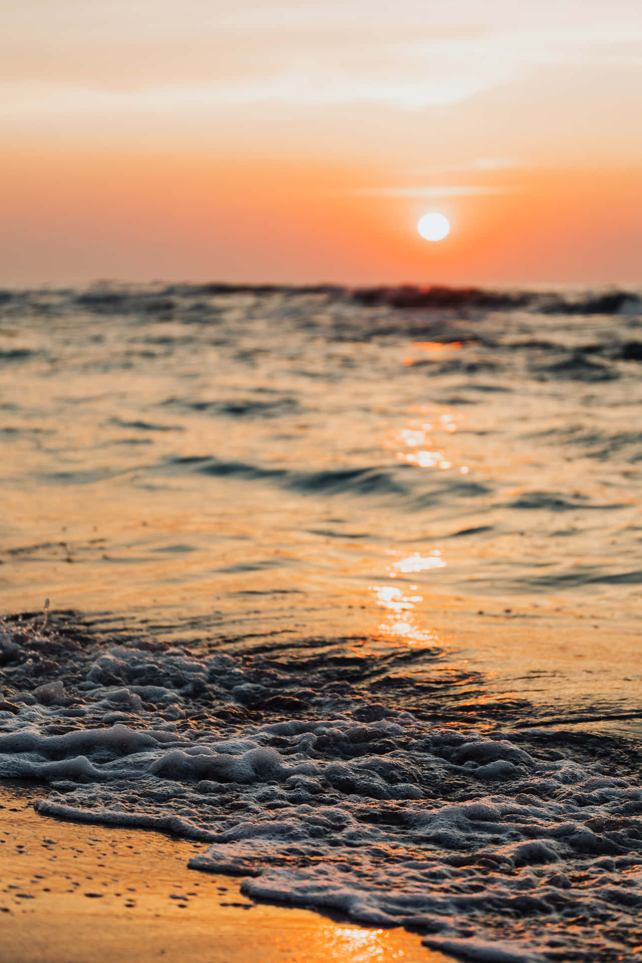 The Colorful Sunrise Over A Wave Background