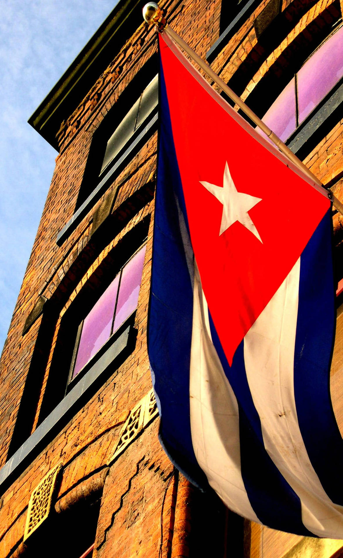 The Cuban Flag Proudly Displayed Outside A Building. Background