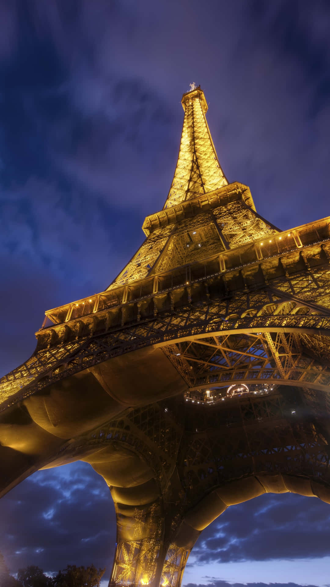 The Eiffel Tower Is Lit Up At Night Background