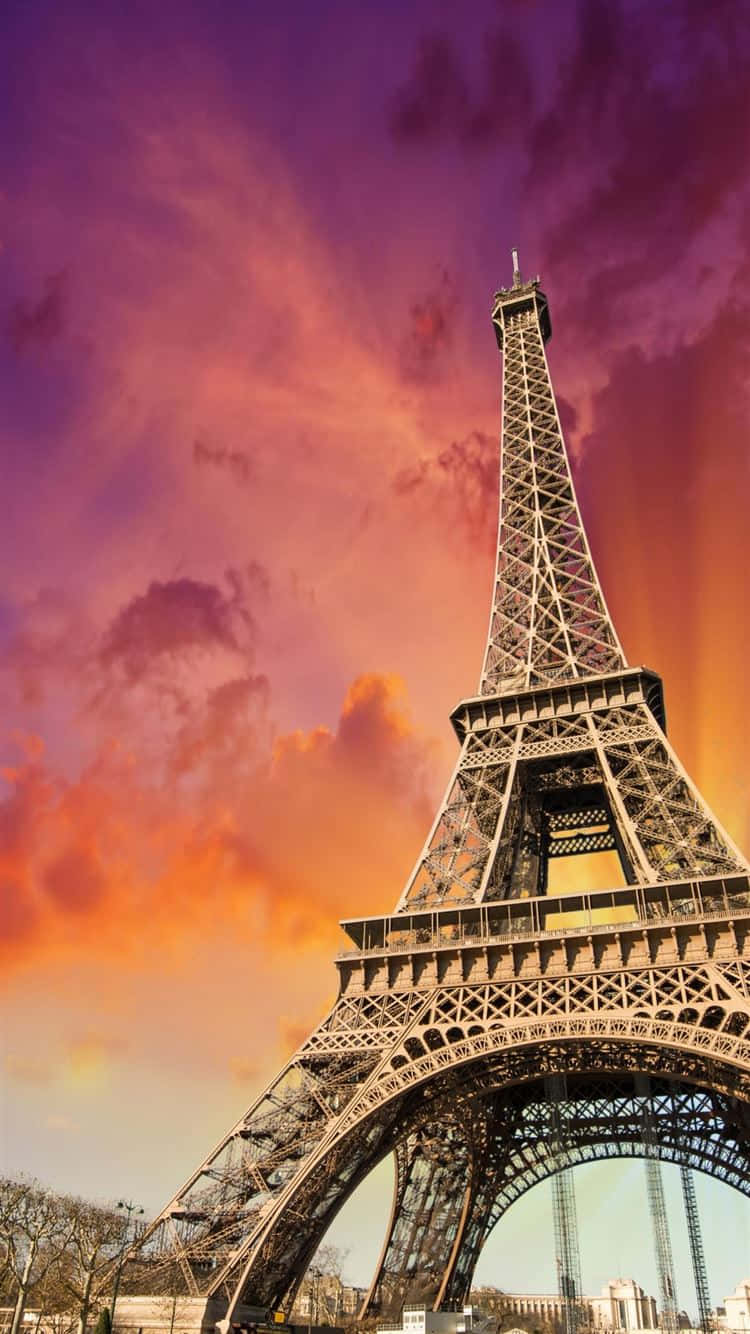 The Eiffel Tower Is Seen In The Sunset Background
