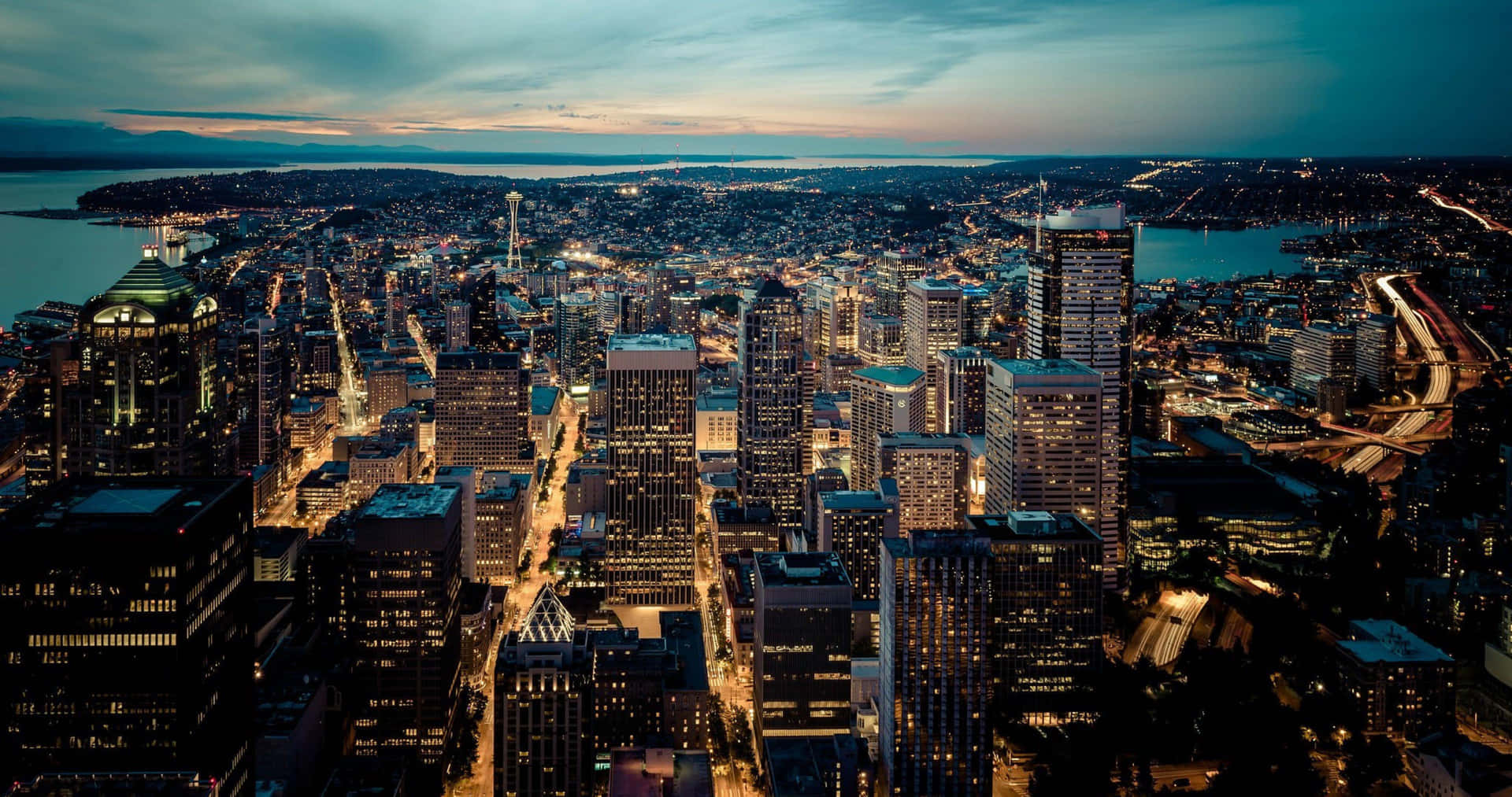 The Emerald City Glows: Seattle At Night Background