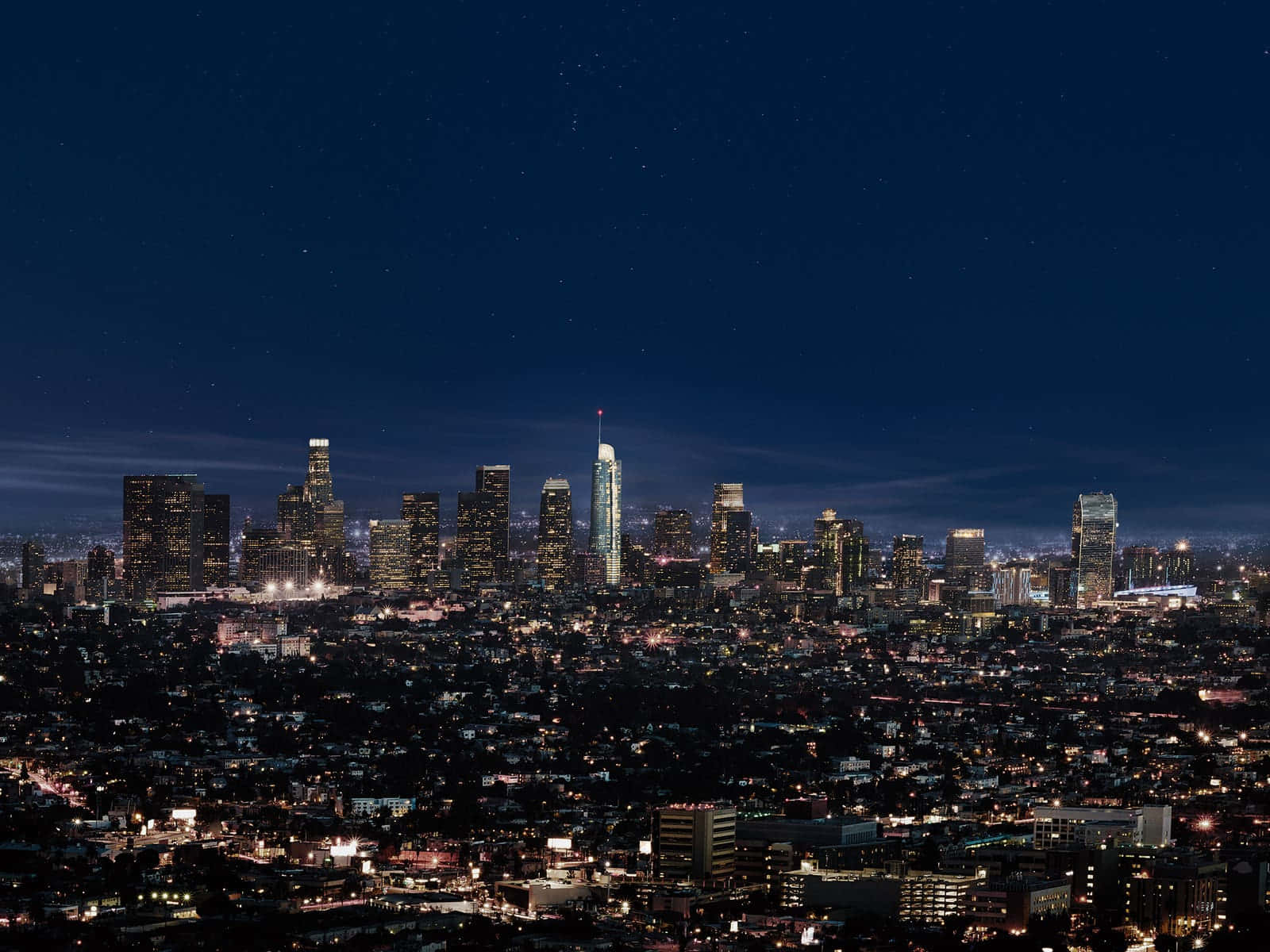 The Enchanting Los Angeles Skyline Embossed By A Star-studded Sky. Background