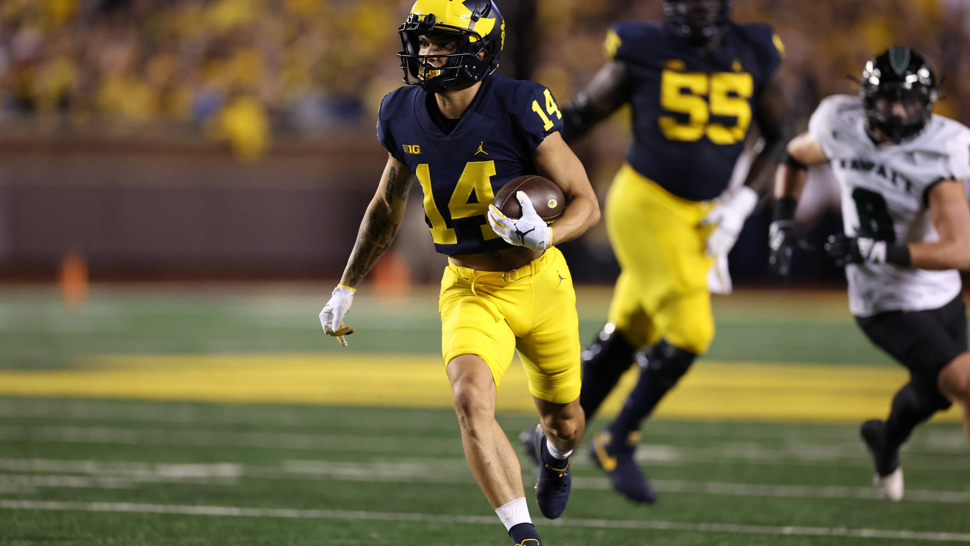 The Energetic Player Of University Of Michigan-ann Arbor Background