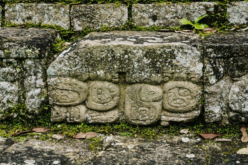 The Enigmatic Mayan Ruins Of Copan Under A Brilliant Blue Sky Background