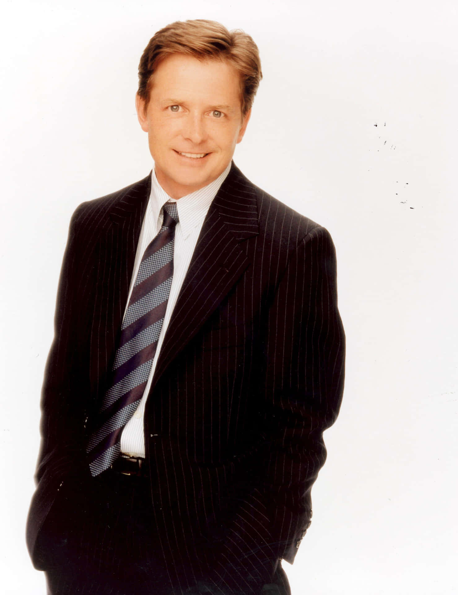 The Enigmatic Smile Of Michael J. Fox Background