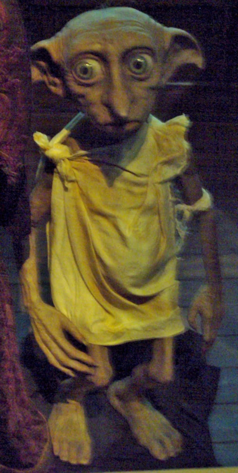 The Faithful House Elf Dobby In A Scene From Harry Potter. Background