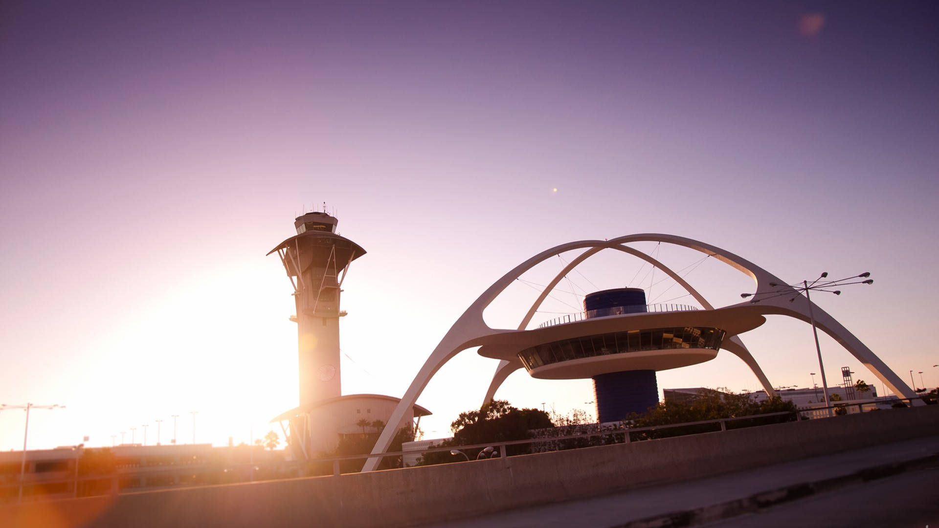 The Famous Los Angeles Theme Building At Lax, Illuminated By The Morning Sun Background