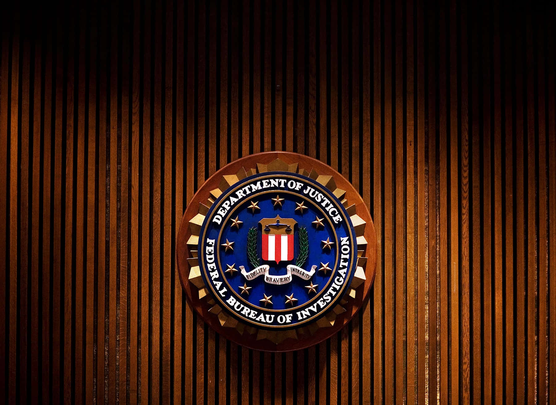 The Fbi Logo Is On A Wooden Wall