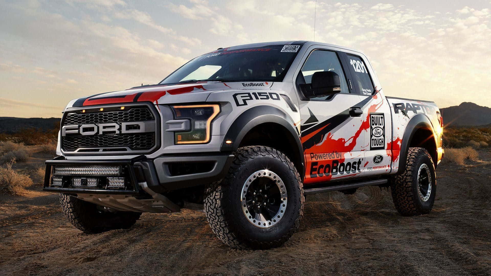 The Ford F - 150 Rpc Is Driving On A Dirt Road Background