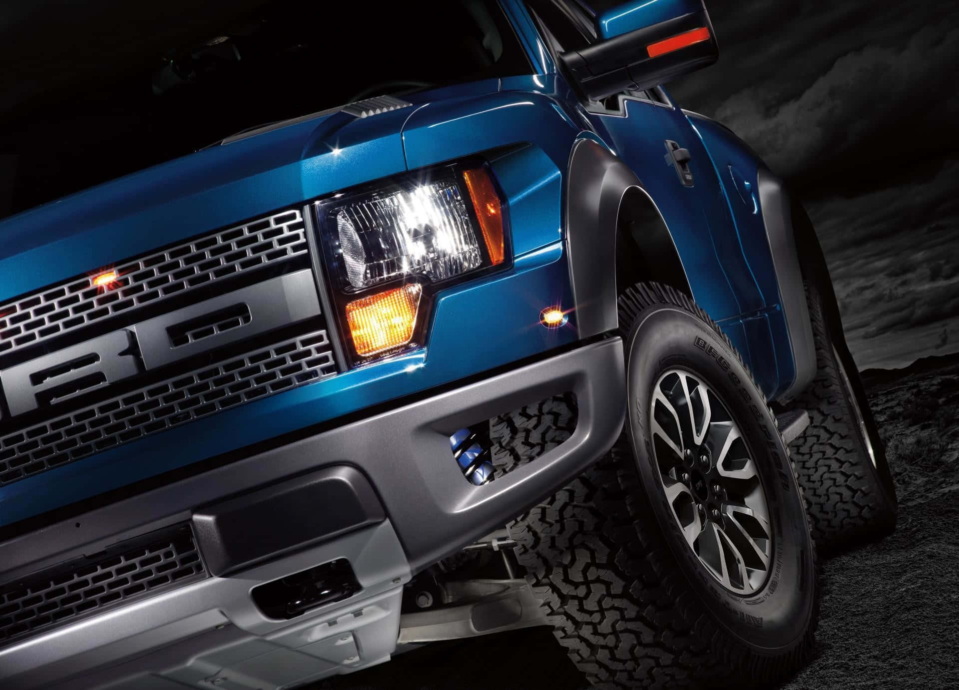 The Front End Of A Blue Ford F - 150 Truck Background