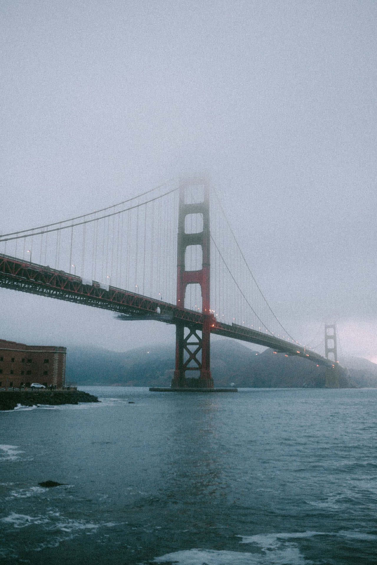 The Golden Gate Bridge Shrouded In San Francisco Fog Background