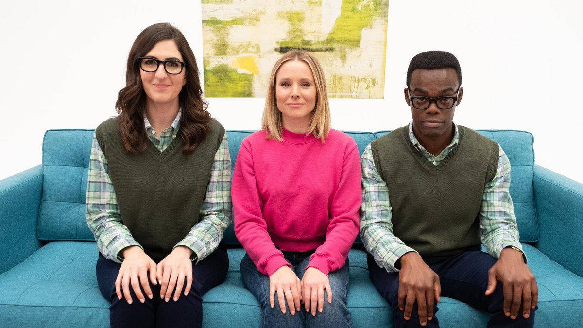 The Good Place Characters Formally Seated On A Couch Background