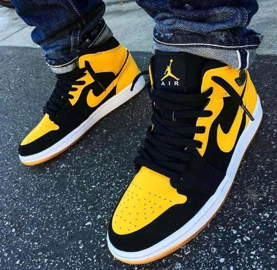 The Iconic Air Jordan Shoes In A Pristine Yellow Color. Background