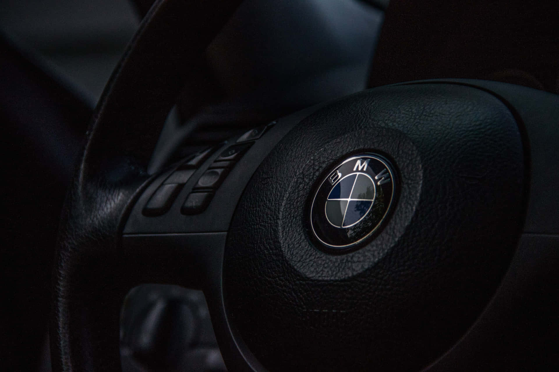 The Iconic Bmw Logo Against A Vibrant Blue Background Background