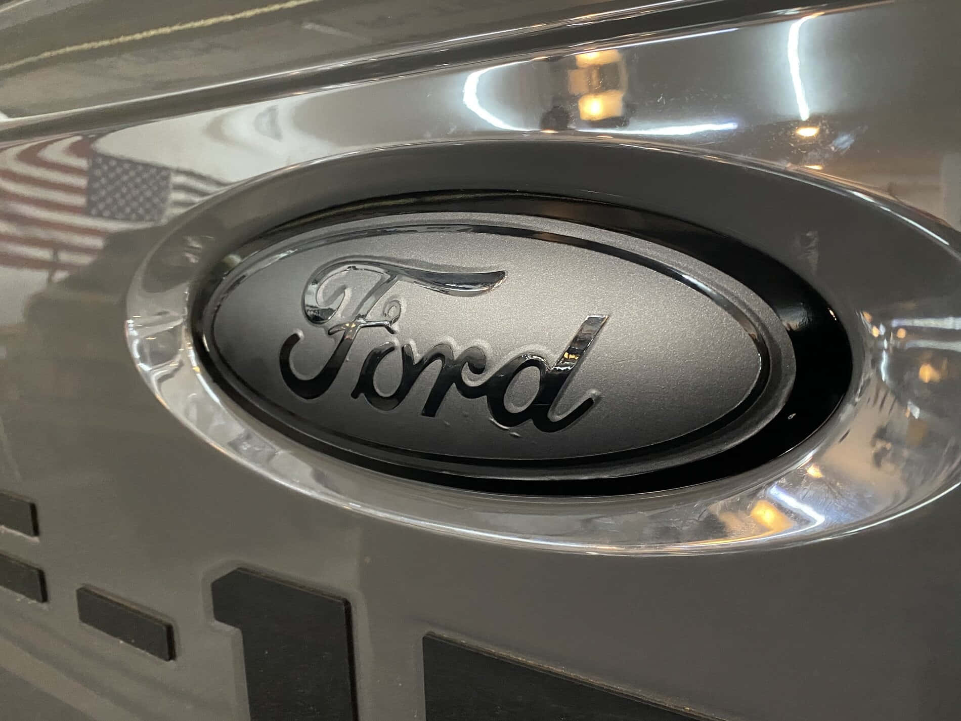 The Iconic Ford Logo On A Dark Background Background