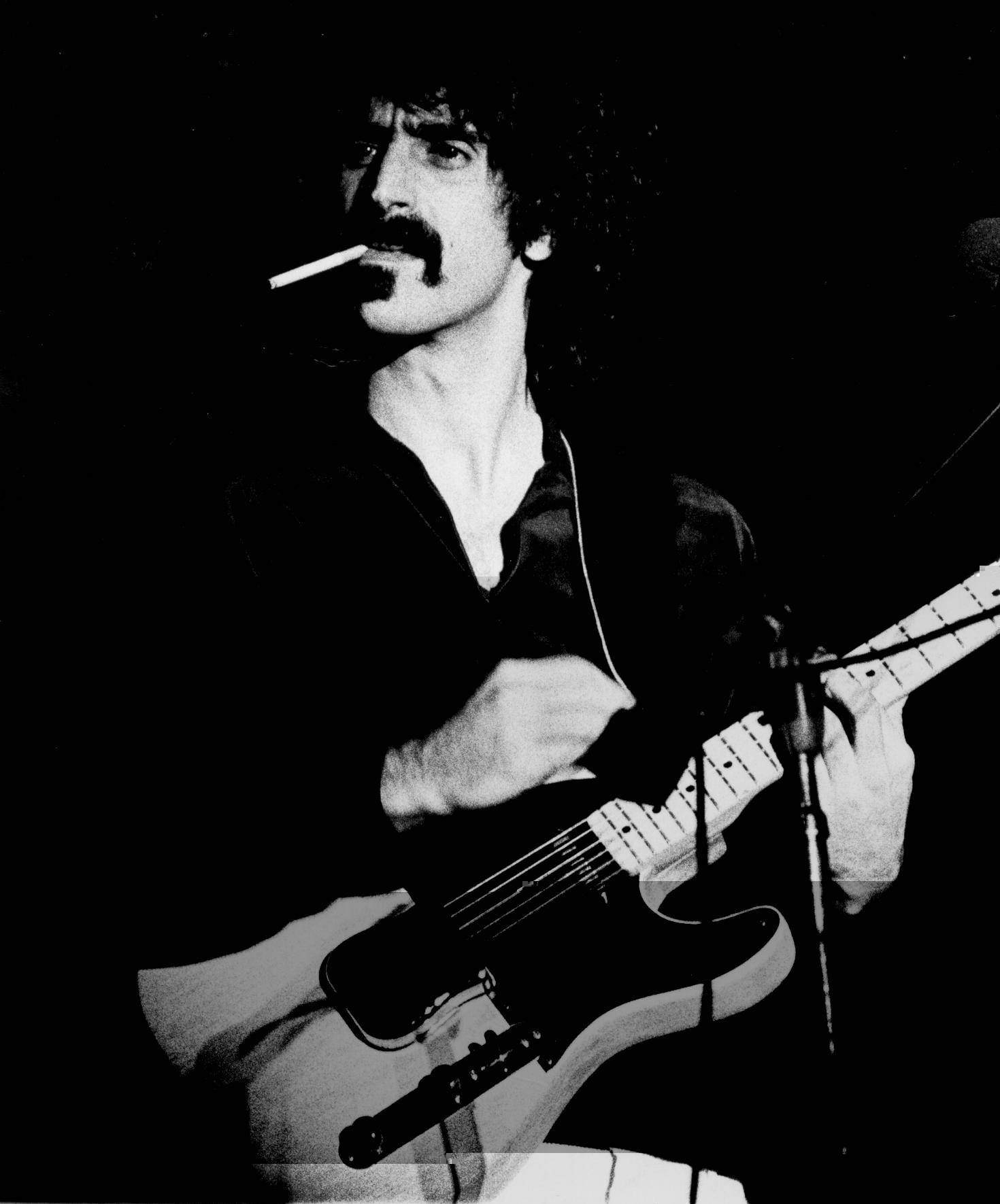 The Iconic Musician Frank Zappa Rocking On Stage Background