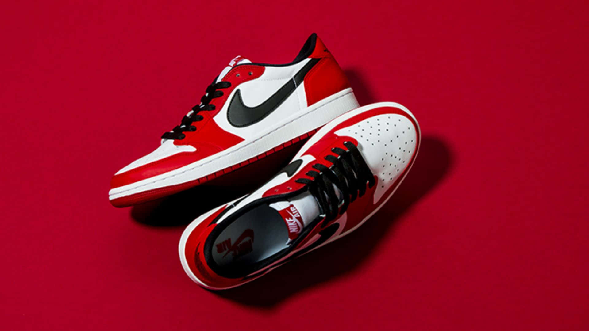 The Iconic Nike Air Jordan 1 Red And White Basketball Sneakers Background