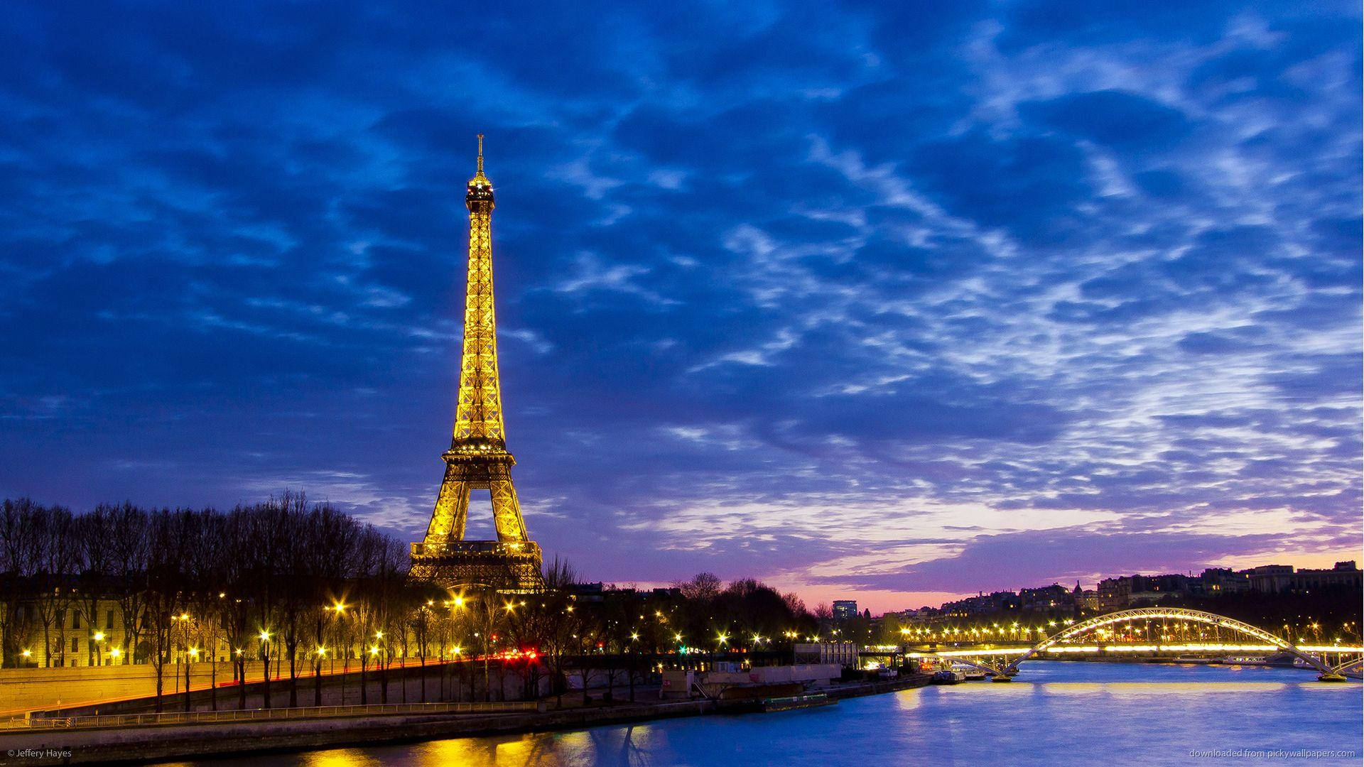 The Iconic Paris Eiffel Tower Overlooking The Seine River Background