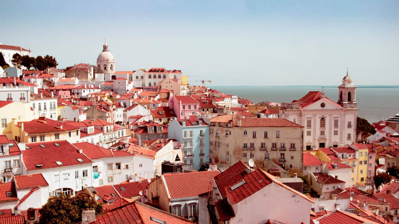 The Idyllic Charm Of Lisbon's Scenic Coastline Background