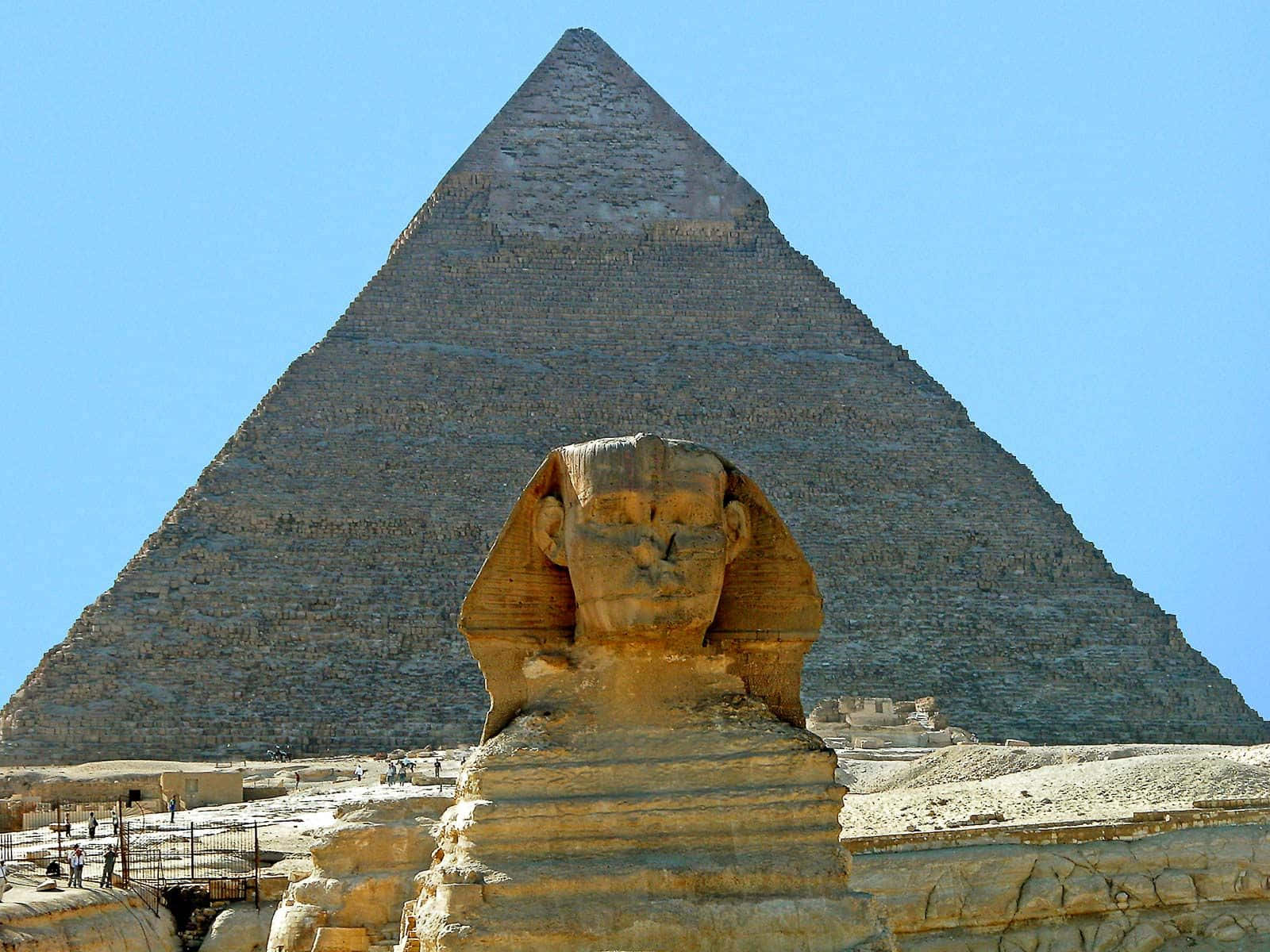 The Imposing Pyramids Of Giza And The Great Sphinx At Dusk Background