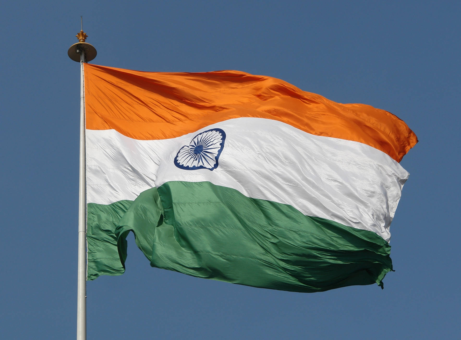 The Indian Tricolor Flag Soaring High Background