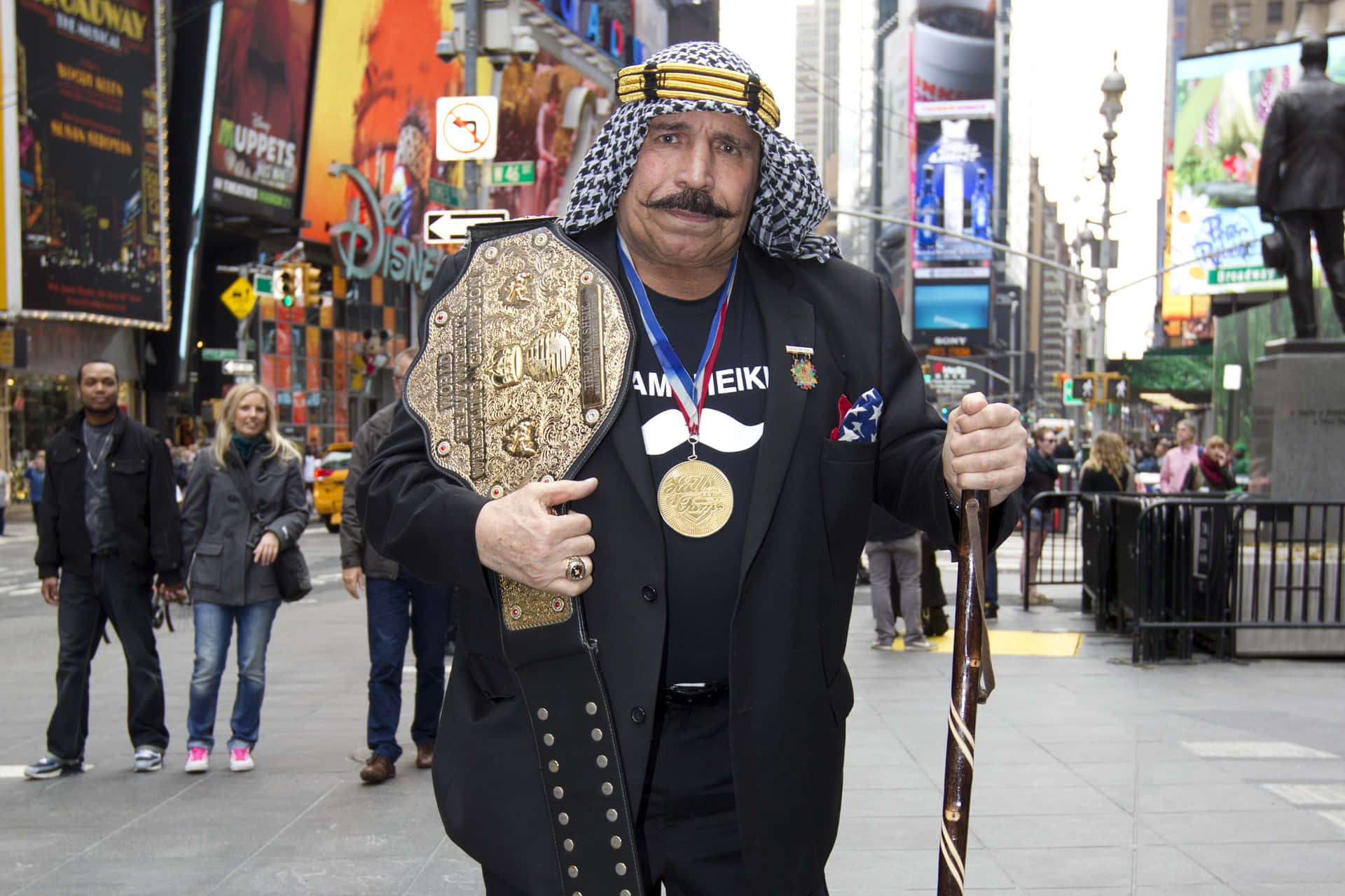 The Iron Sheik Holding Belt Background