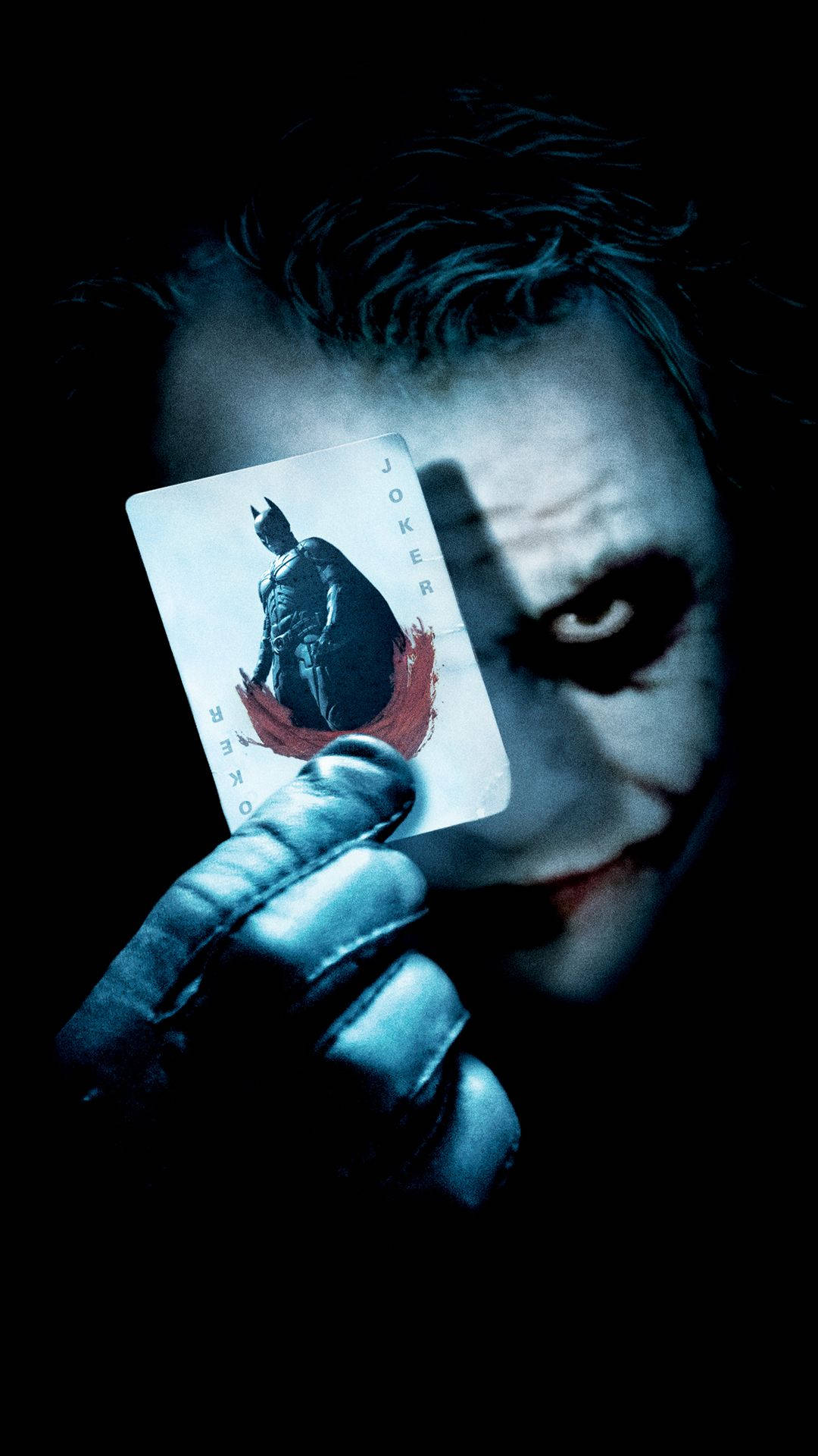 The Joker Holding A Playing Card