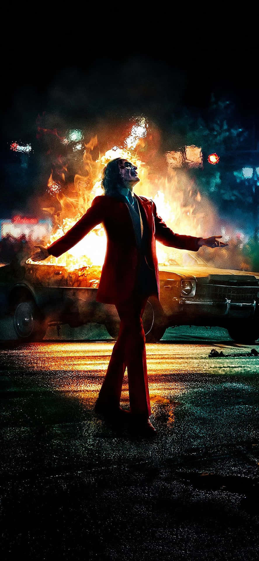 The Joker Movie Poster With A Man In Red Standing In Front Of A Car