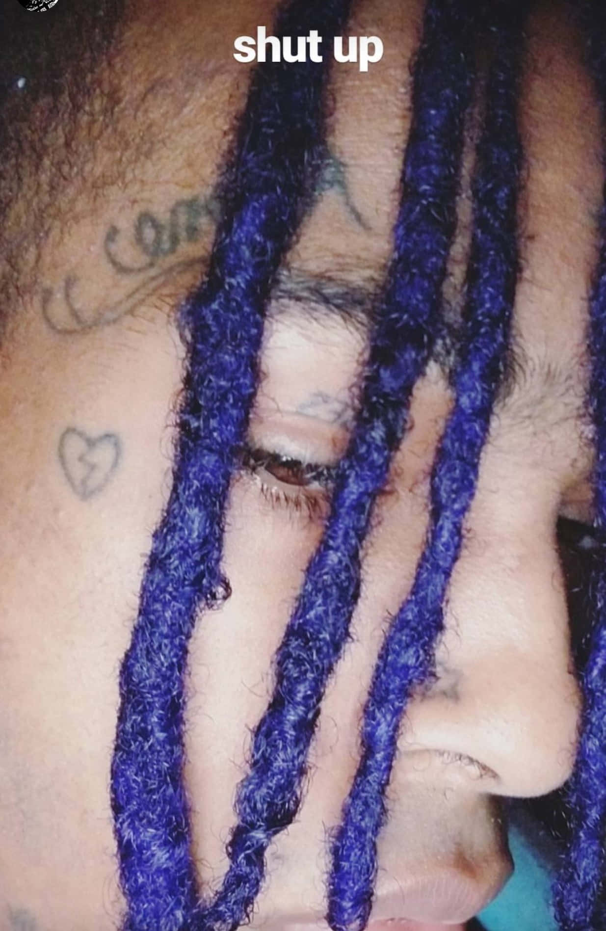 The Late American Rapper Xxxtentacion Sporting His Iconic Blue Hair Background