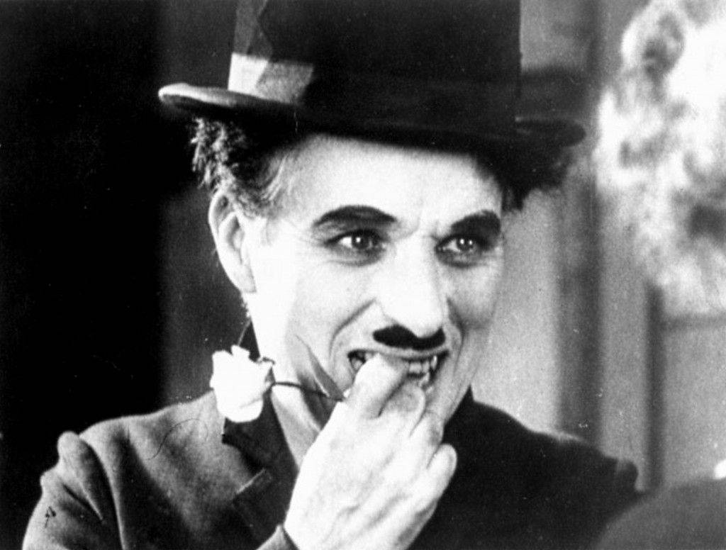 The Legendary Actor Charlie Chaplin Cracks A Nervous Smile Background