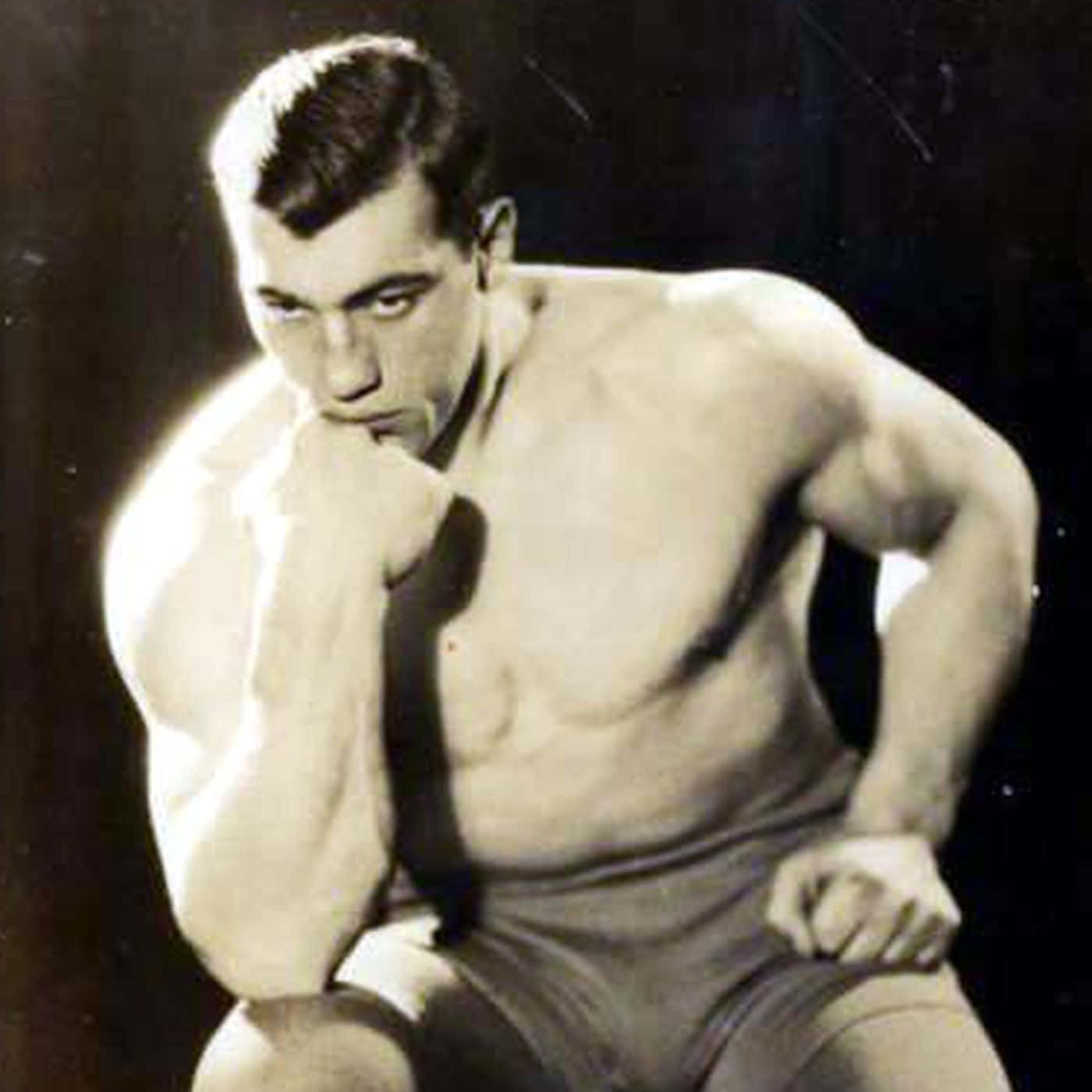The Legendary Italian Boxer, Primo Carnera, Mirroring The Thinker Pose Background