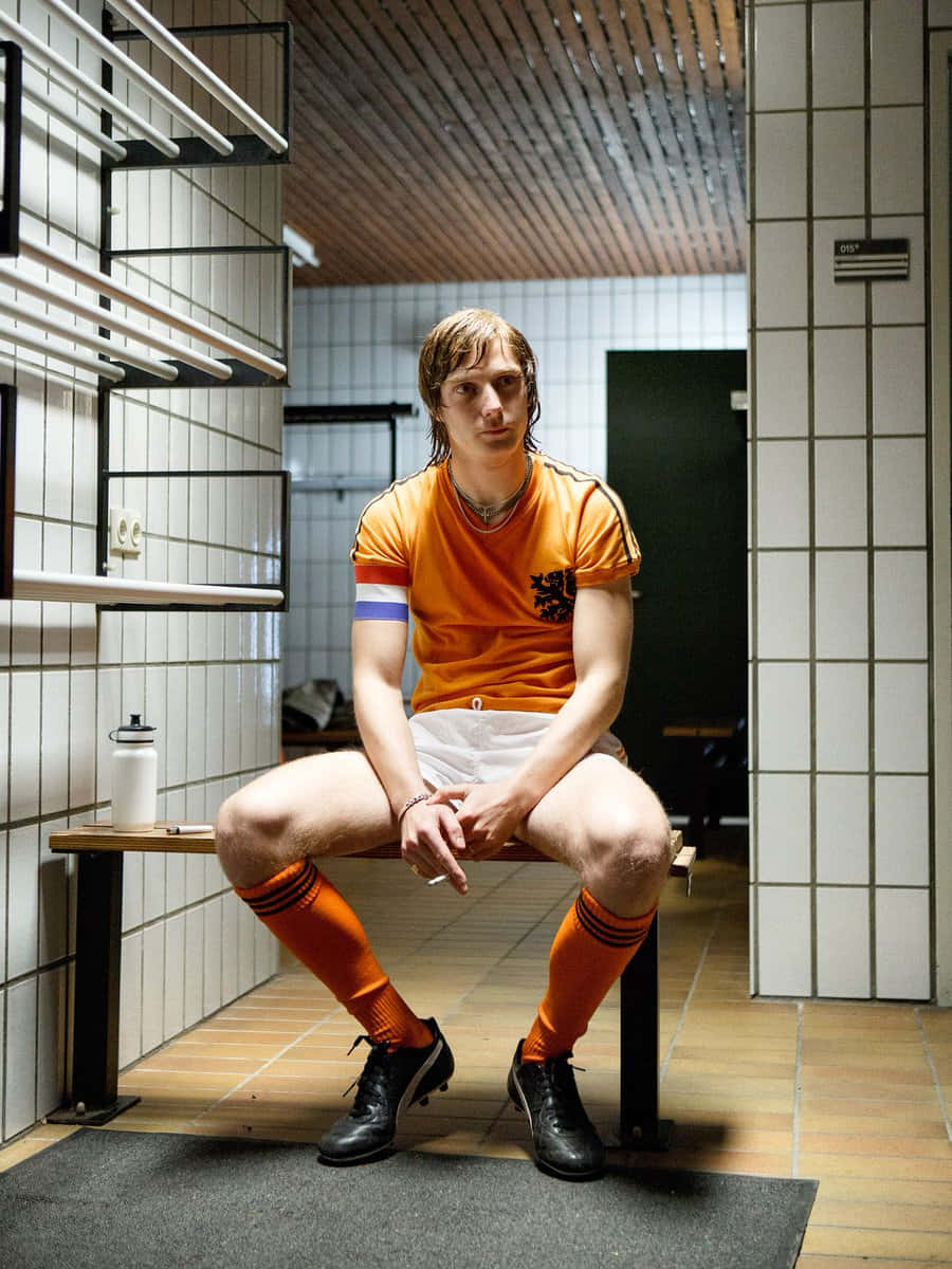 The Legendary Johan Cruyff Relaxing On A Bench Background