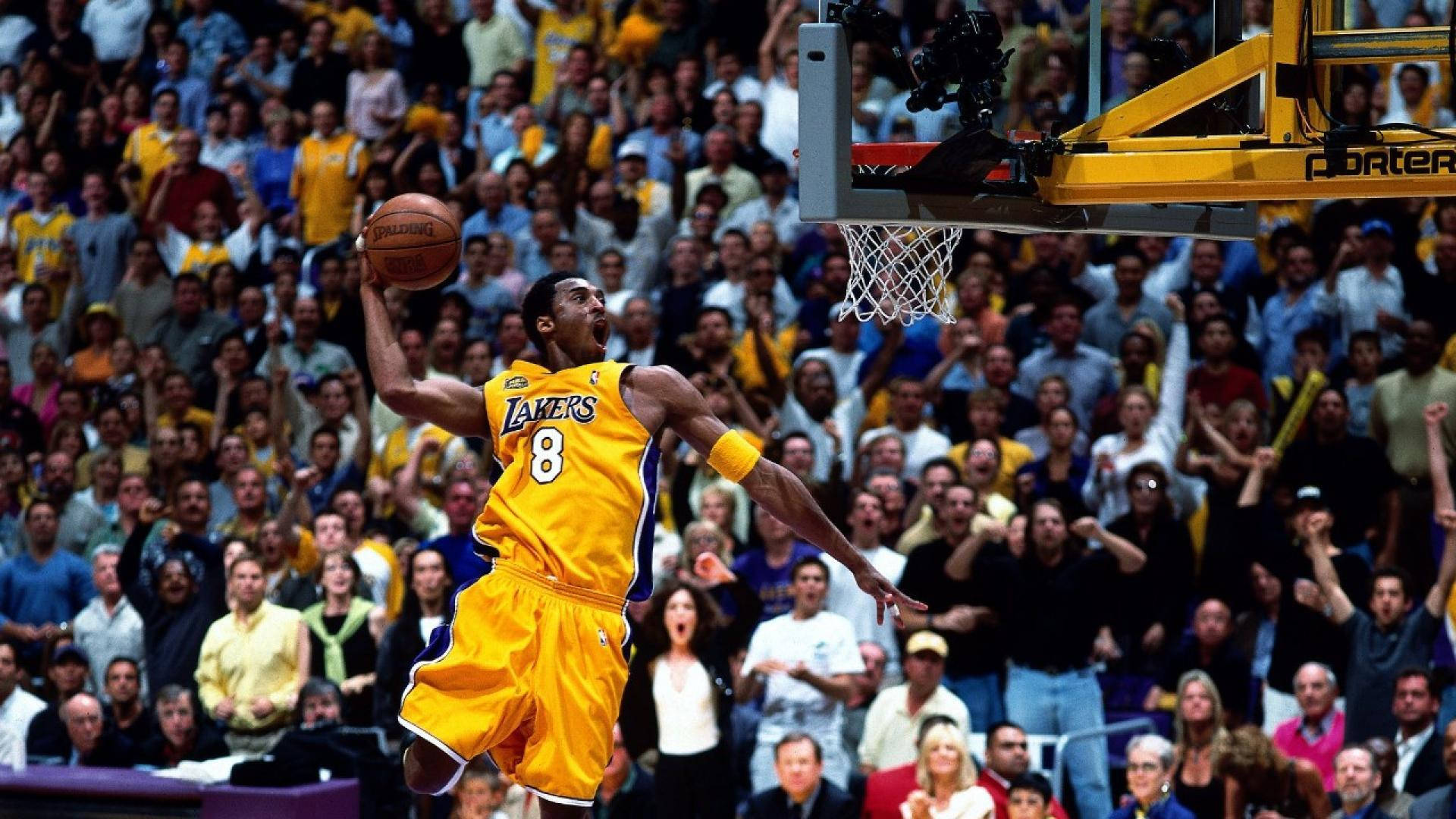 The Legendary Kobe Bryant Showing Off His Signature Dunk Move Background