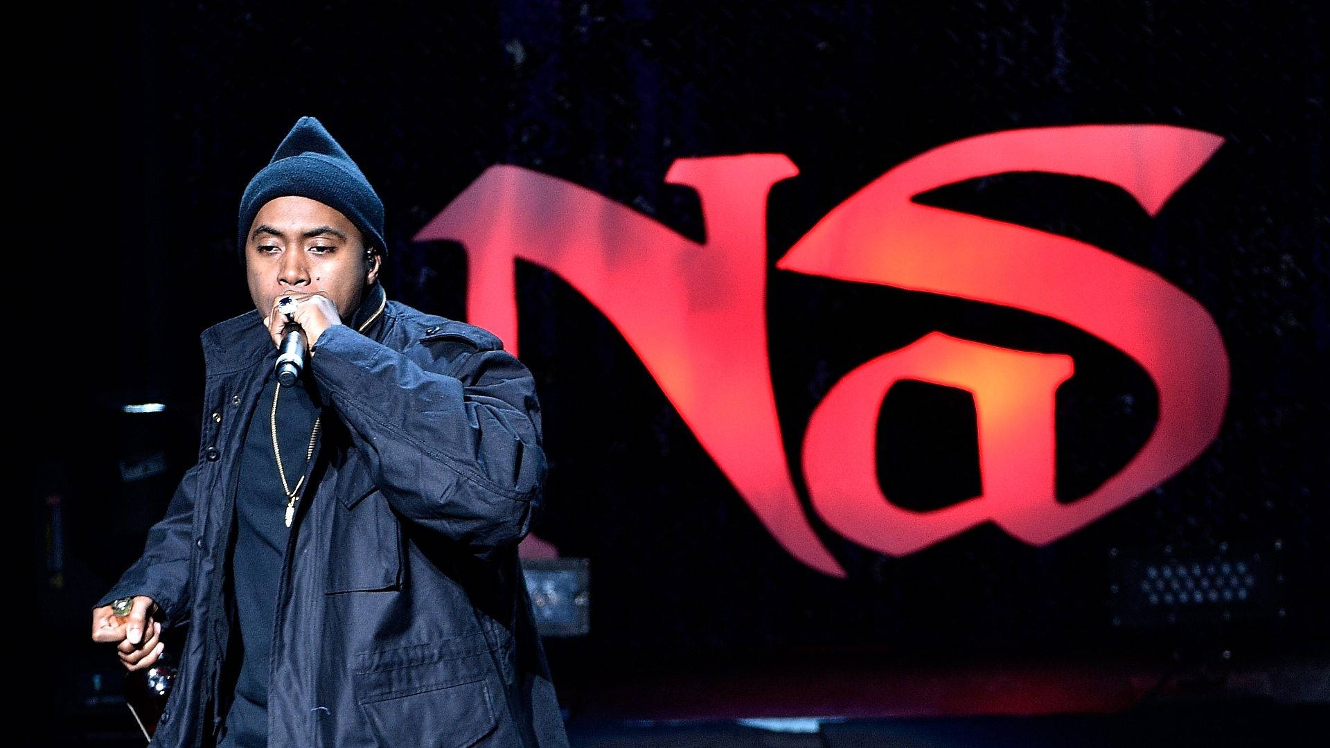 The Legendary Rapper Nas Delivering A Powerful Performance Onstage Background