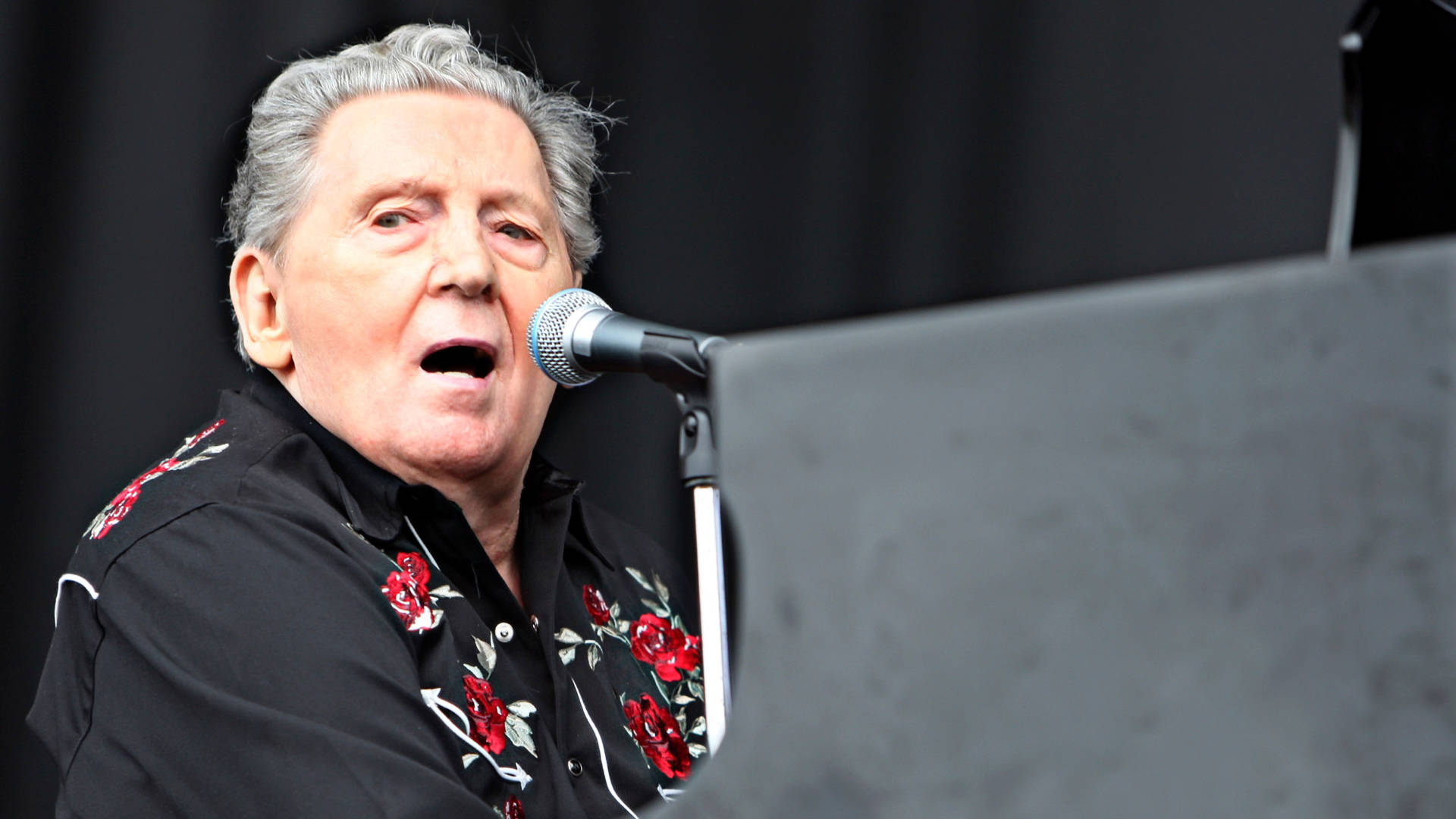 The Legendary Rock N’ Roll Pianist, Jerry Lee Lewis In A Pensive Profile Shot. Background