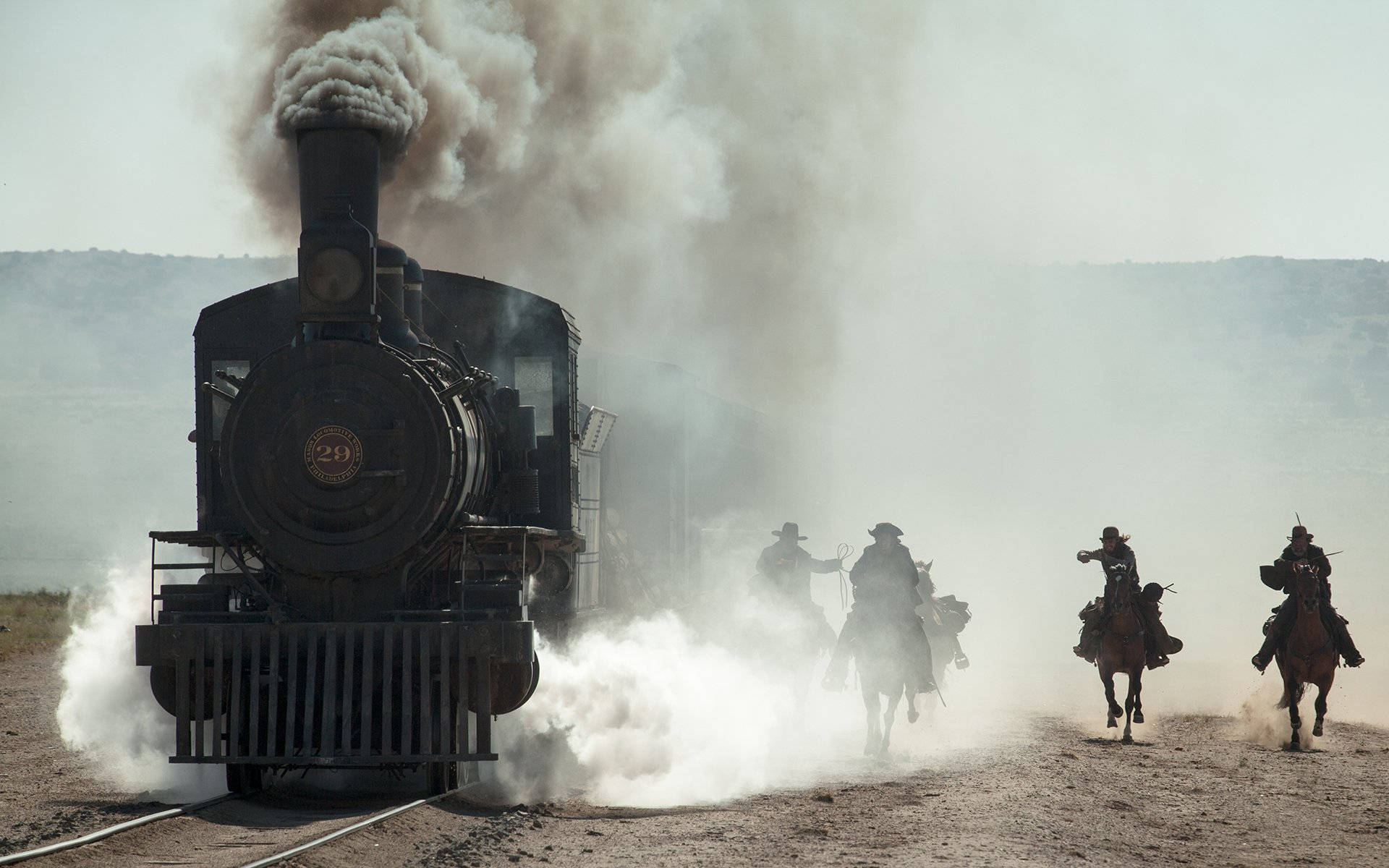 The Lone Ranger And Tonto On Horseback Overlooking A Steam Train. Background