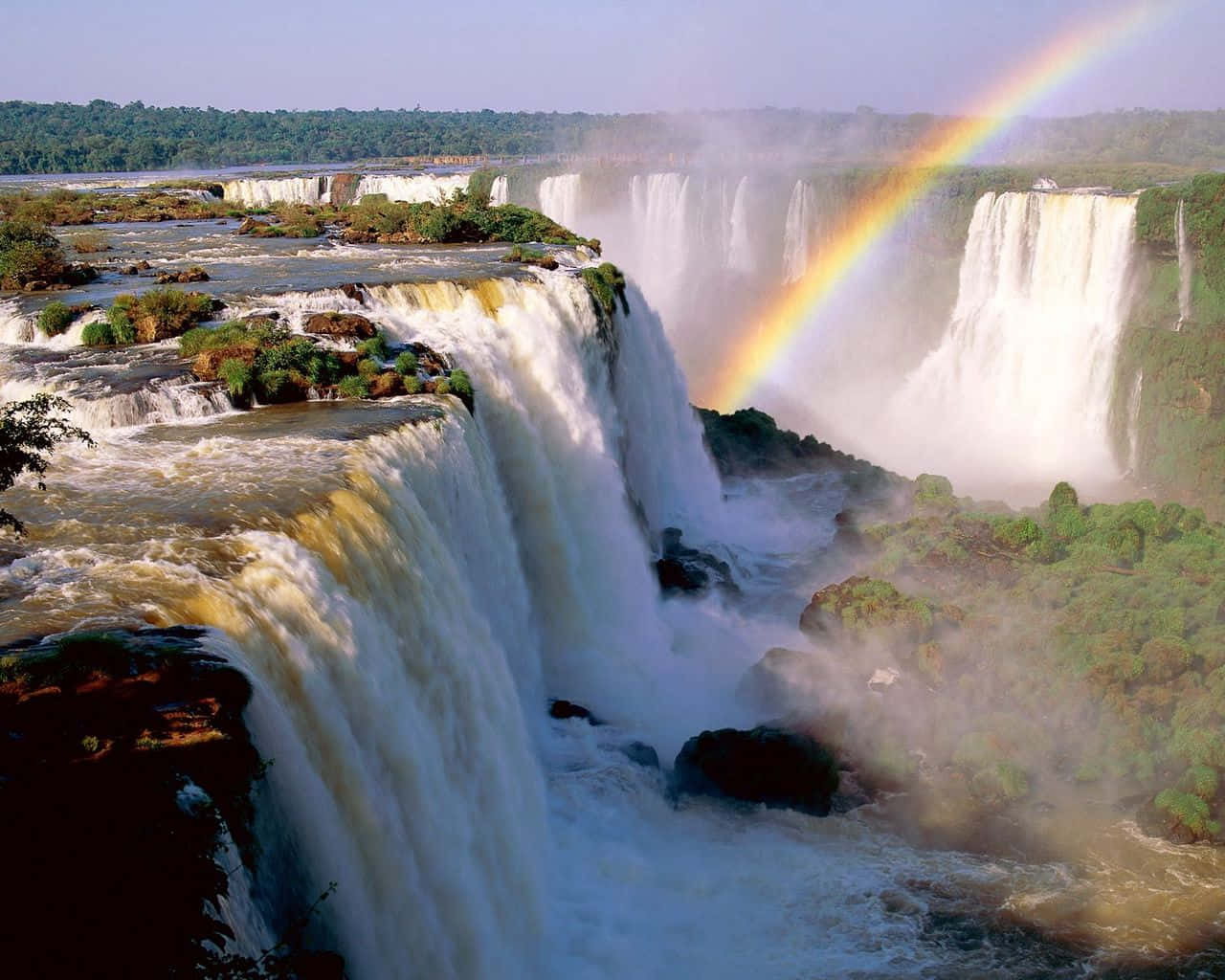 The Majestic Iguazu Falls Embraced By A Stunning Rainbow