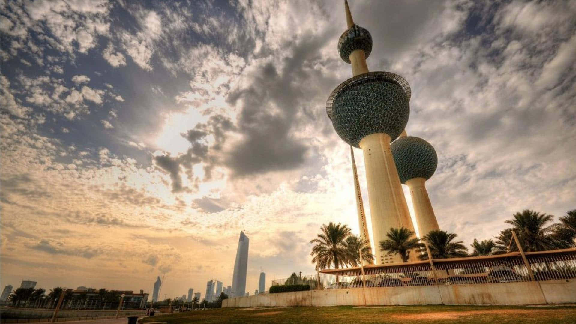 The Majestic Kuwait Towers Under A Magnificently Cloudy Sky Background