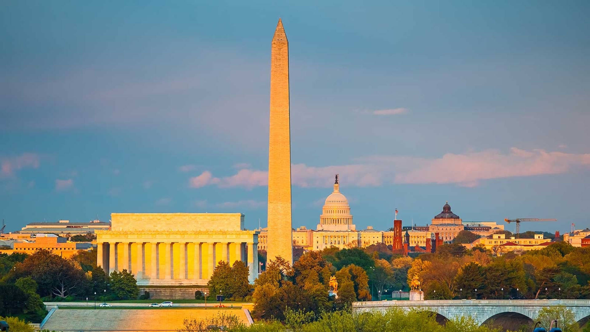 The Majestic Washington Monument At A Golden Sunset Background