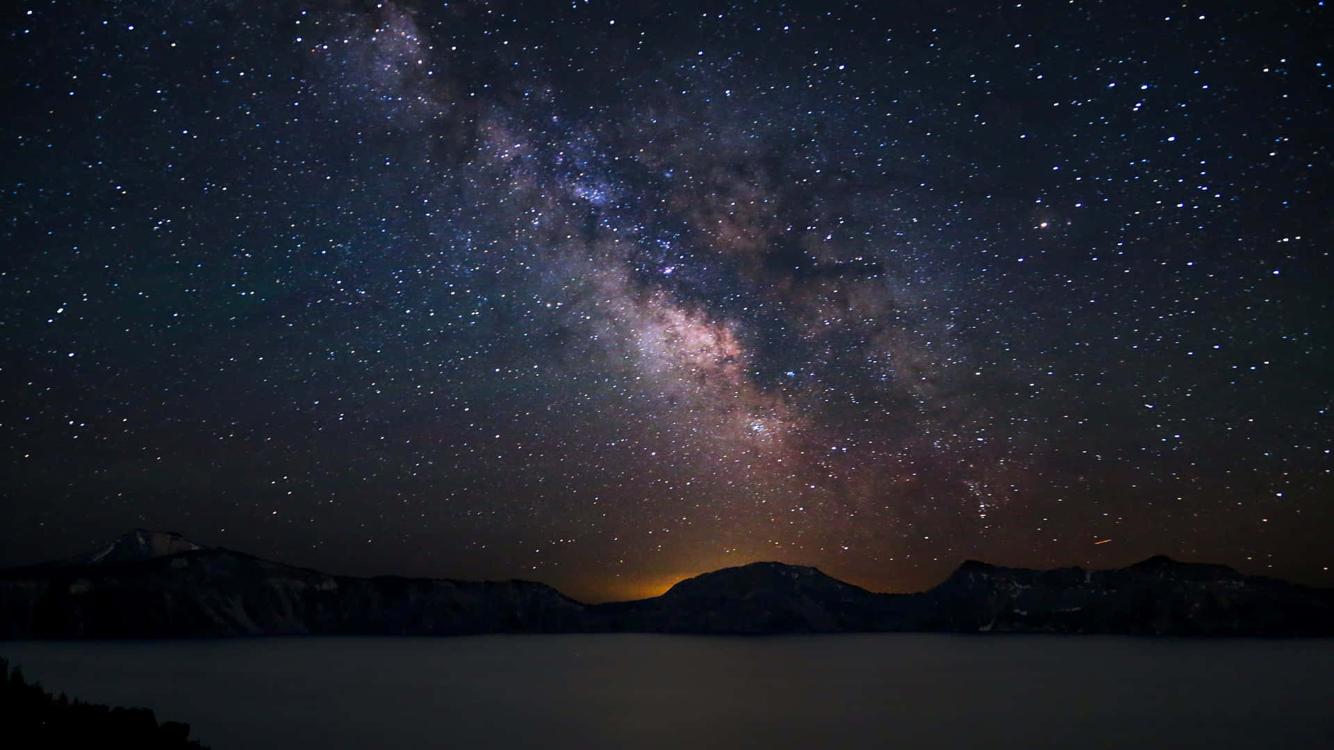 The Milky Over A Lake With Mountains In The Background Background